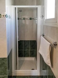 a shower with a glass door in a bathroom at Villa Charlotte in Protaras