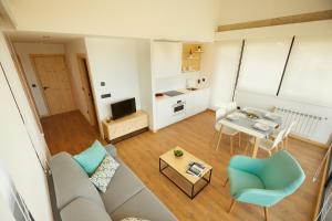 a living room with a couch and a table at Apartamentos Arumes do Mar e Montaña - Viveiro in Viveiro