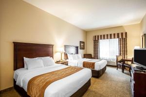 a hotel room with two beds and a television at Comfort Inn & Suites McMinnville Wine Country in McMinnville