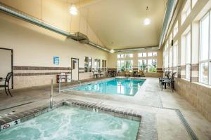 a pool in a building with a swimming pool at Comfort Inn & Suites McMinnville Wine Country in McMinnville