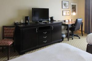 a hotel room with a television on top of a dresser at Quality Inn & Suites Alexandria in Alexandria