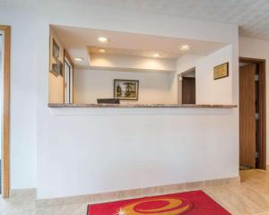 an empty lobby with a counter and a red rug at Econo Lodge in Saint Albans