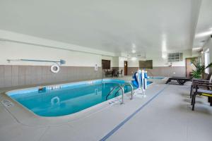 a large swimming pool with a blue pool at Comfort Suites Omaha East-Council Bluffs in Council Bluffs