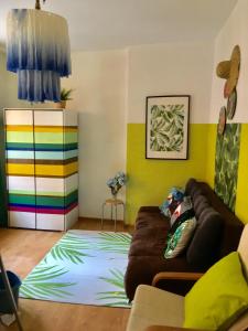a living room with a couch and a colorful rug at Apartament 14 przy ul. Długiej in Gdańsk