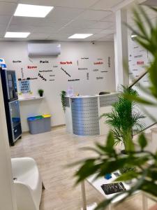 an office with a white wall with graphs on it at Time Out ApartHotel in Casalecchio di Reno
