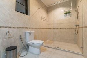 a bathroom with a toilet and a shower at AnB poolvilla 2BR with private beach in pratamnak in Pattaya South