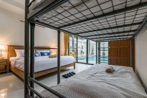 a bedroom with two bunk beds and a balcony at AnB poolvilla 2BR with private beach in pratamnak in Pattaya South