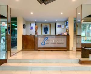 a store front with a gate house sign in a building at Inspire House Hotel in Chiang Mai