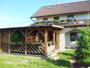 a house with a wooden fence and flower boxes on it at Penzion Piano Ranch in Mladá Boleslav