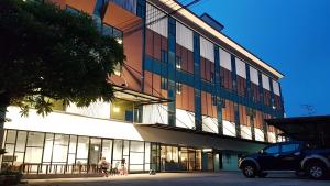 a building with a truck parked in front of it at บ้านเลขที่ 3 in Phitsanulok