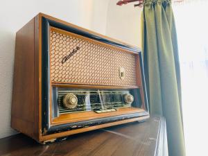an old radio sitting on the floor next to a window at Casa Teutsch in Sighişoara