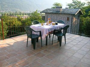 a table and chairs sitting on a patio at Al Carotin in Mantello