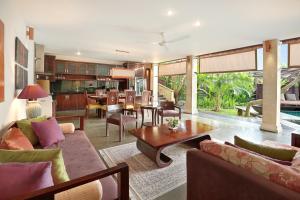 an open living room with a dining room and kitchen at Gending Kedis Luxury Villas & Spa Estate in Jimbaran