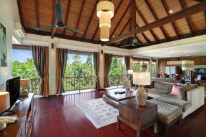 a living room with a couch and a table at Gending Kedis Luxury Villas & Spa Estate in Jimbaran