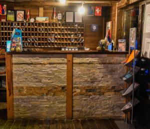 a bar in a restaurant with a brick wall at JollyKop Apartments in Kopaonik