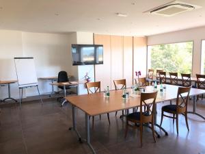 a classroom with tables and chairs and a whiteboard at Le Diana Hôtel & Spa NUXE in Carnac +37 photos
