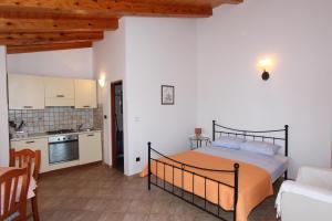 a bedroom with a bed in a room with a kitchen at Apartments Villa Mara in Rovinj