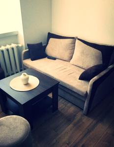 a living room with a couch and a table at M&M apartamenty in Zamość