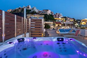a bath tub sitting on top of a balcony at Angels Suites in Plataniás