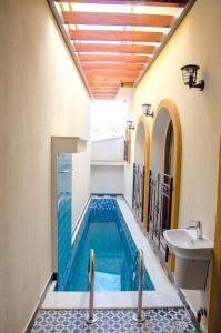 a swimming pool in a house with a sink at Kasbah Shirin in Selçuk