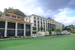 ein Gebäude mit einem grünen Feld davor in der Unterkunft Haile Resort-Gondar in Gonder