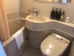 a small bathroom with a toilet and a sink at Chitose Airport Hotel in Chitose +43 photos