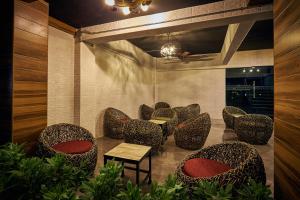 a waiting area with chairs and a table in a room at Sweetloft Hotel Don Muang in Bangkok
