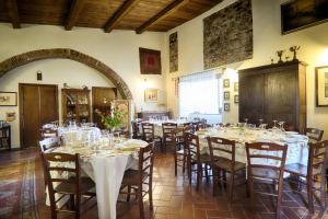 un comedor con mesas y sillas con manteles blancos en Agriturismo Giardino di Iti, en Rossano