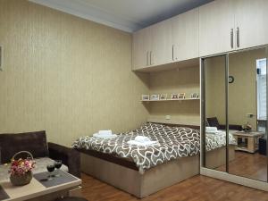 a bedroom with a bed and a living room at Apartment in Tbilisi in Tbilisi City