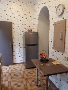 a kitchen with a table and a refrigerator at Apartment in Tbilisi in Tbilisi City