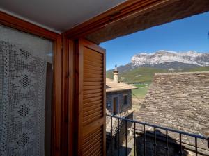 een kamer met een raam met uitzicht op een berg bij Apartamento Casa Dueso in El Pueyo de Araguás