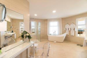 a bathroom with a tub and a sink at Royal Palm Resort & Spa - Adults Only in Playa Jandia