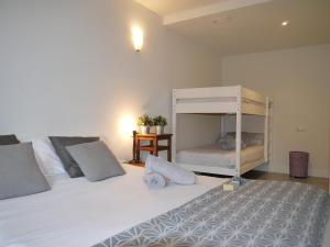 a bedroom with a large white bed and a bunk bed at Apartamento Atari in San Martín
