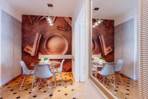 a dining room with two tables and a mirror at 4Seasons﻿ Apartments Cracow in Krakow