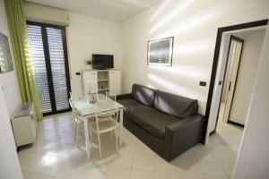 a living room with a couch and a small table at Residenza Sol Holiday in Rimini