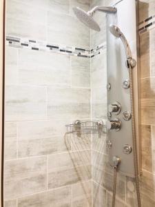 a shower with a shower head in a bathroom at L'Atelier in Beauvais