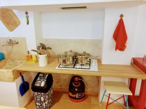 a kitchen with a counter with pots and pans on it at Casa Visconde de Alcácer in Setúbal