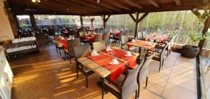 a dining room with tables and chairs in a restaurant at Apartments Jadranka in Malinska