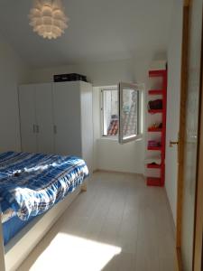 a bedroom with a bed and a window and a mirror at Modern apartmant in old city in Piran
