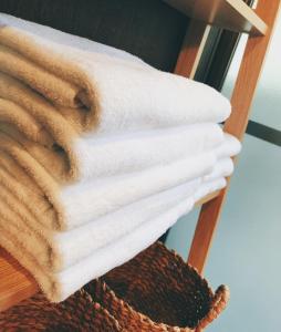 a stack of towels on a towel rack at Kyoto Inari Guest House Tonoya villa in Kyoto