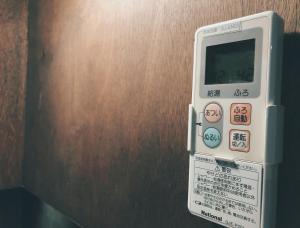 a remote control is attached to a wall at Kyoto Inari Guest House Tonoya villa in Kyoto