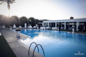 a large swimming pool next to a building at Hotel Giulia Ocean Club in Qualiano