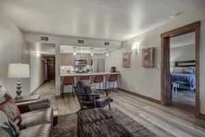 a living room with a couch and a kitchen at 241C Mountain Side Condo in Frisco