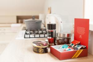 a counter top with a box of food and a coffee maker at "U Mamy Róży" - Pokoje Gościnne in Reda