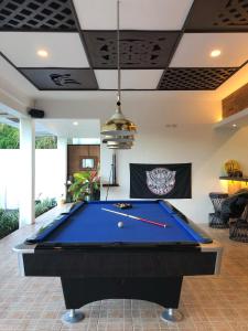 a pool table in the middle of a living room at Alona Vikings Lodge in Panglao Island