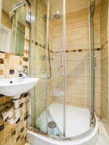 a bathroom with a shower and a sink at The Park Hotel in London +58 photos