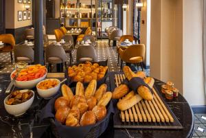 a buffet of food on a table in a restaurant at Lenox Montparnasse in Paris