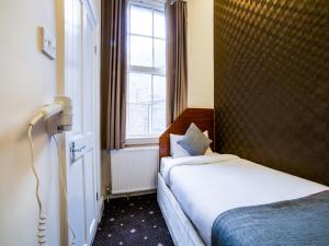 a hotel room with two beds and a window at The Park Hotel in London