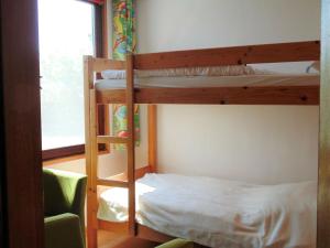 a bedroom with two bunk beds and a window at Bungalow in Damshagen nahe der Ostsee in Reppenhagen