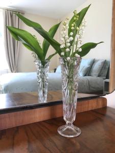 a glass vase with white flowers on a table at Southwell in Southwell
